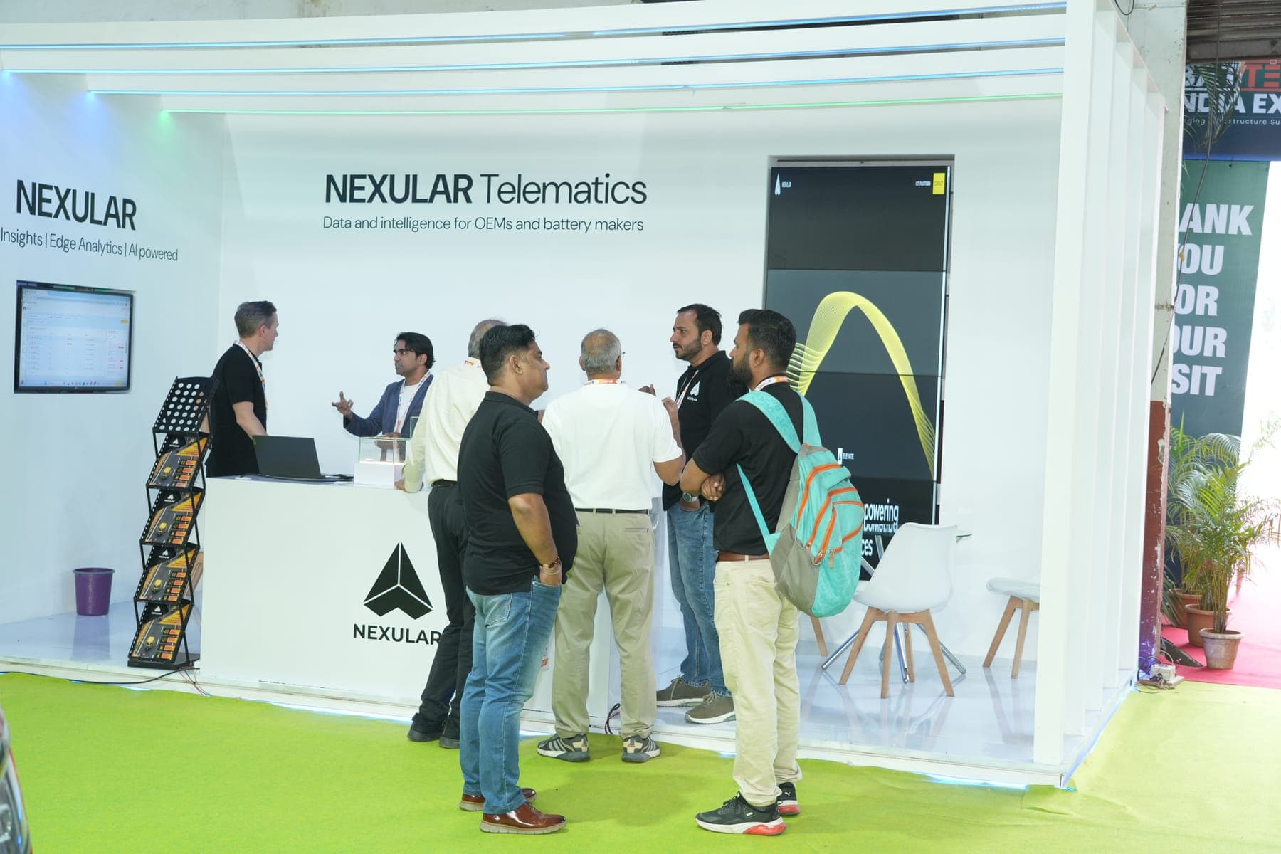 Exhibitors and visitors in discussion at a technology booth at a previous edition