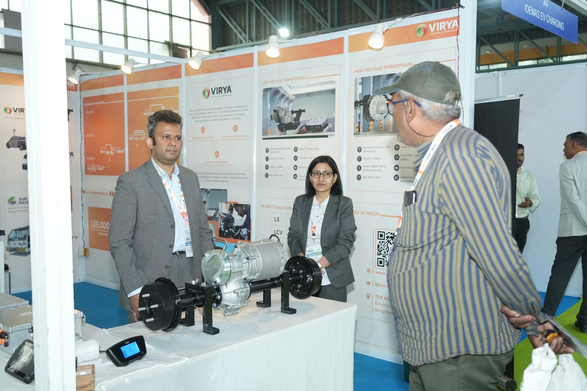 An exhibitor demonstrating an EV powertrain to visitors at a previous edition